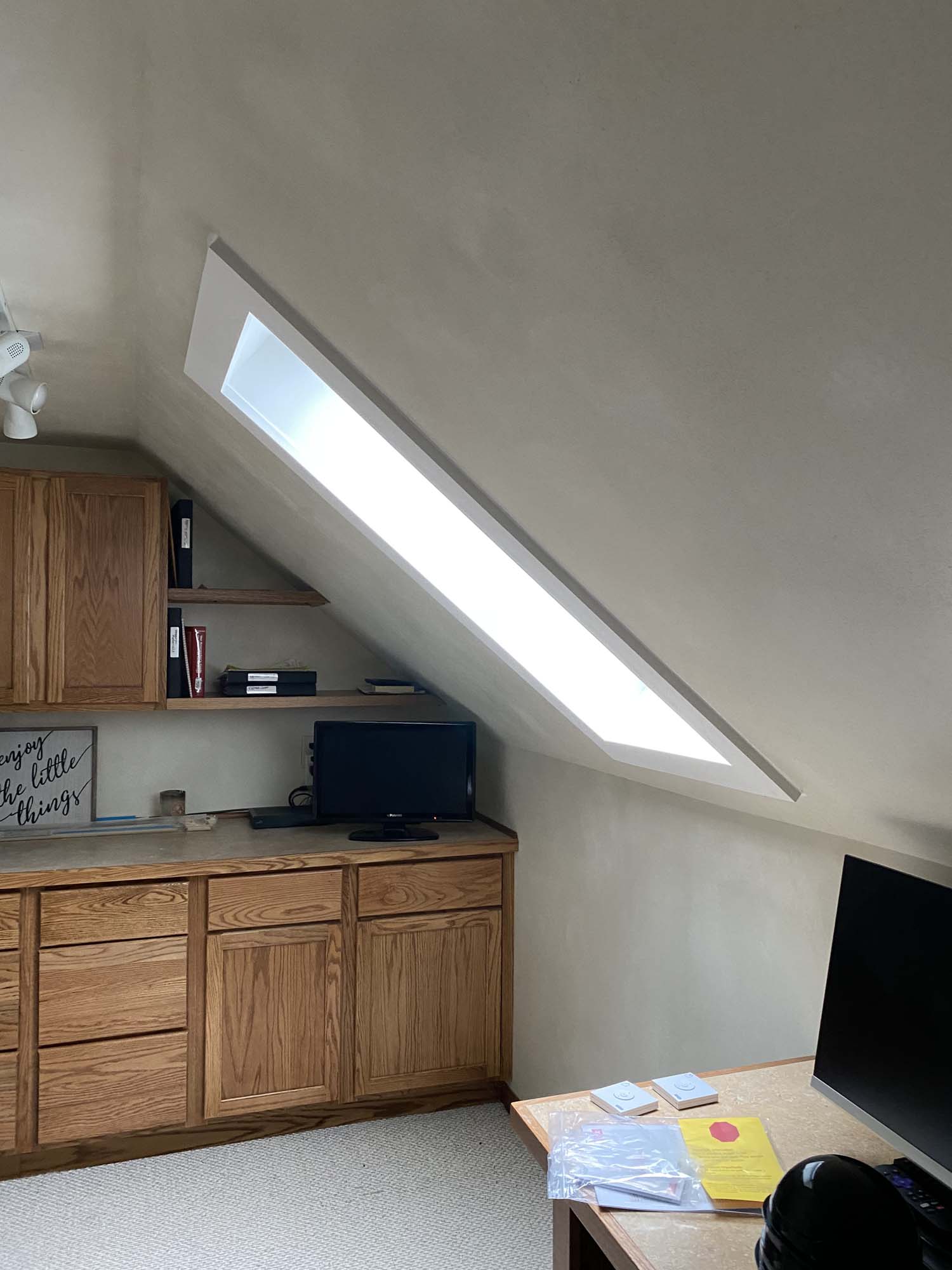 Rectangular VELUX skylight shines in on a home office in an A-frame room installed by Wisconsin Sunlight Solutions.
