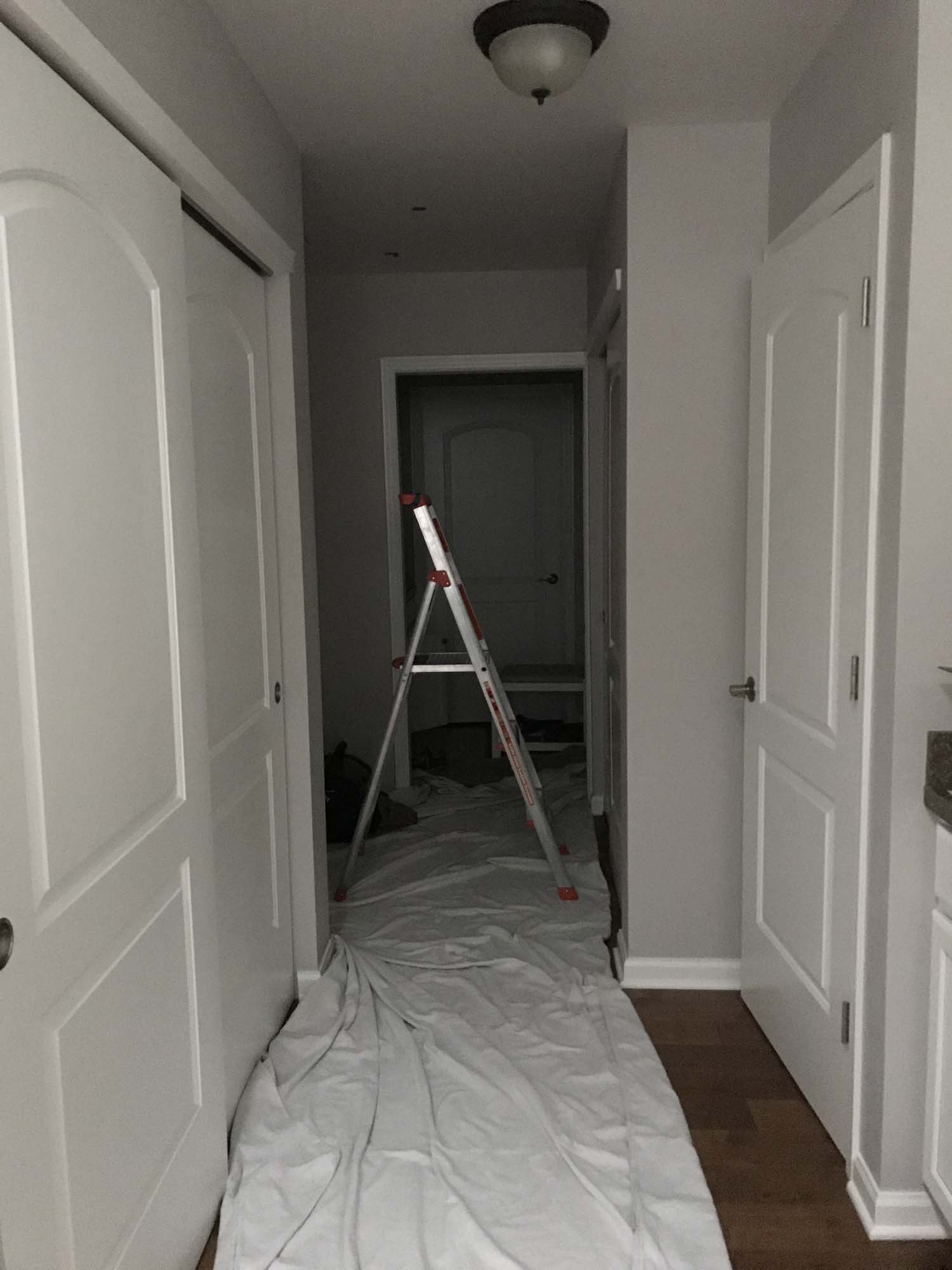 Ladder and drop-cloth sit in a home entry way before a skylight installation