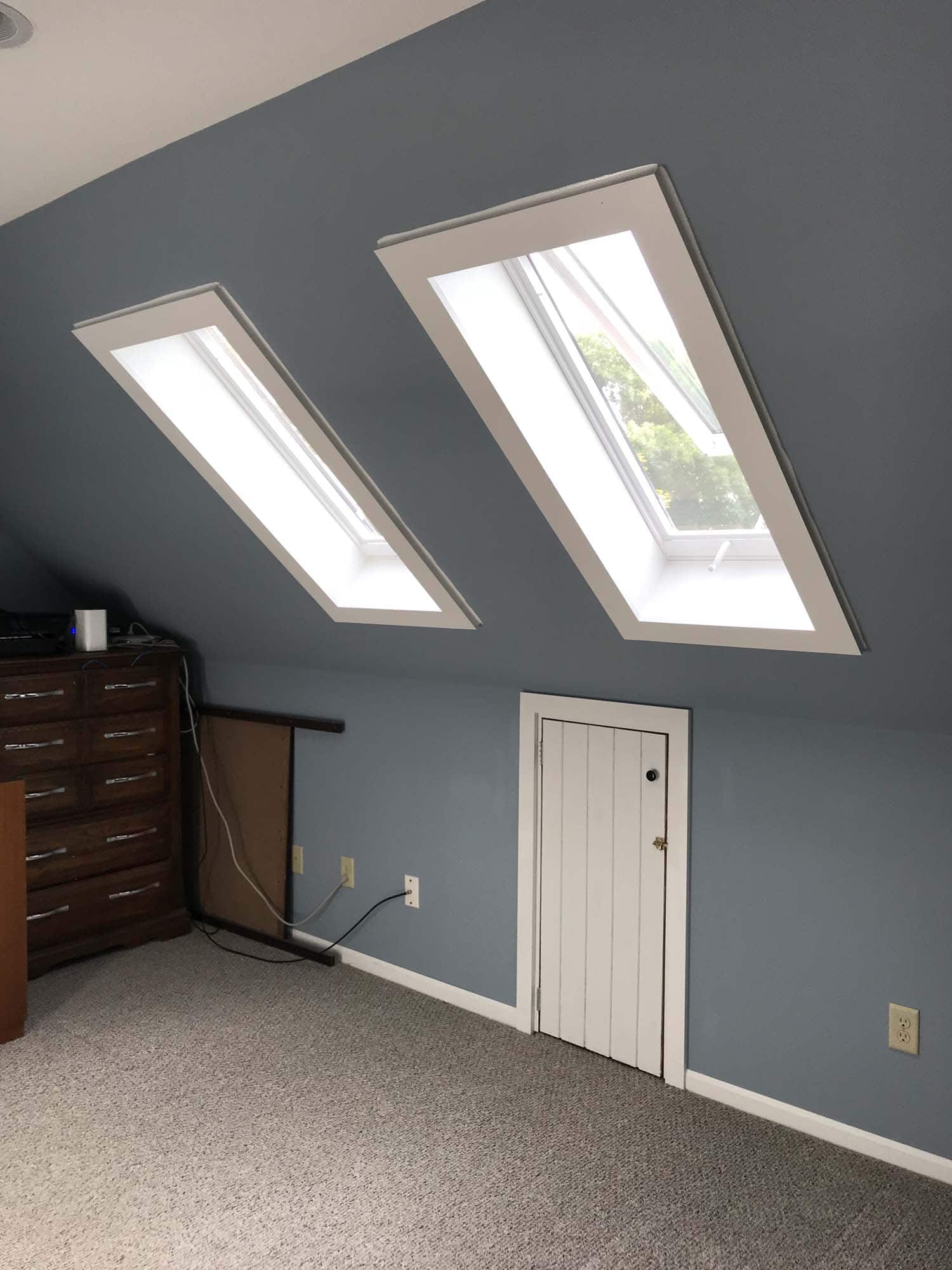 Two rectangular skylights looking in on a light blue room