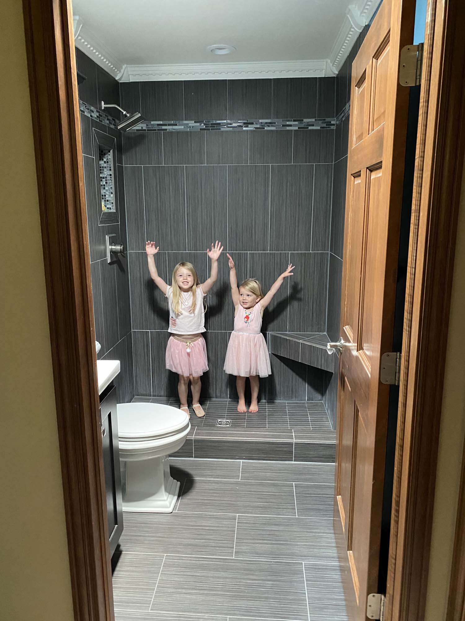 Two young girls are super happy they are getting a skylight in their bathroom