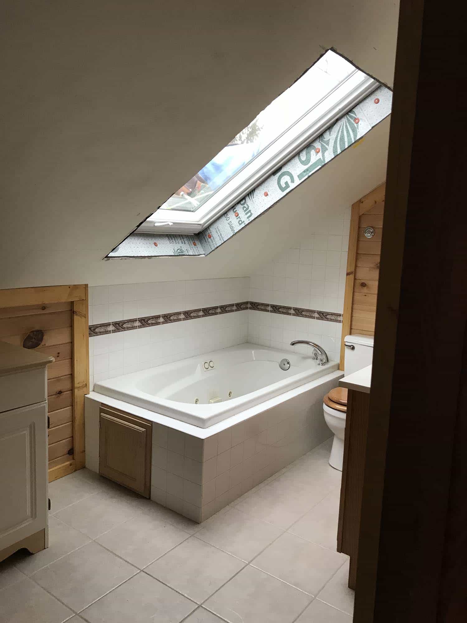 Rectangular skylight overlooks a bathtub