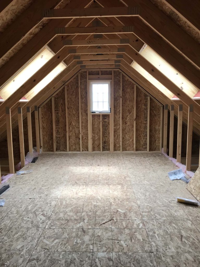 Two large square VELUX skylights light up an A-frame attic space installed by Wisconsin Sunlight Solutions.