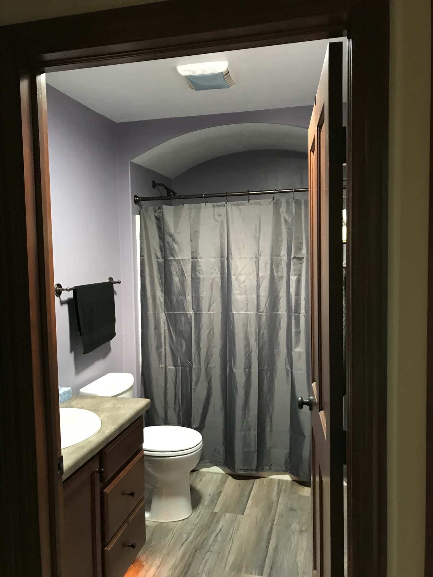 Small square skylight illuminates a hall bathroom